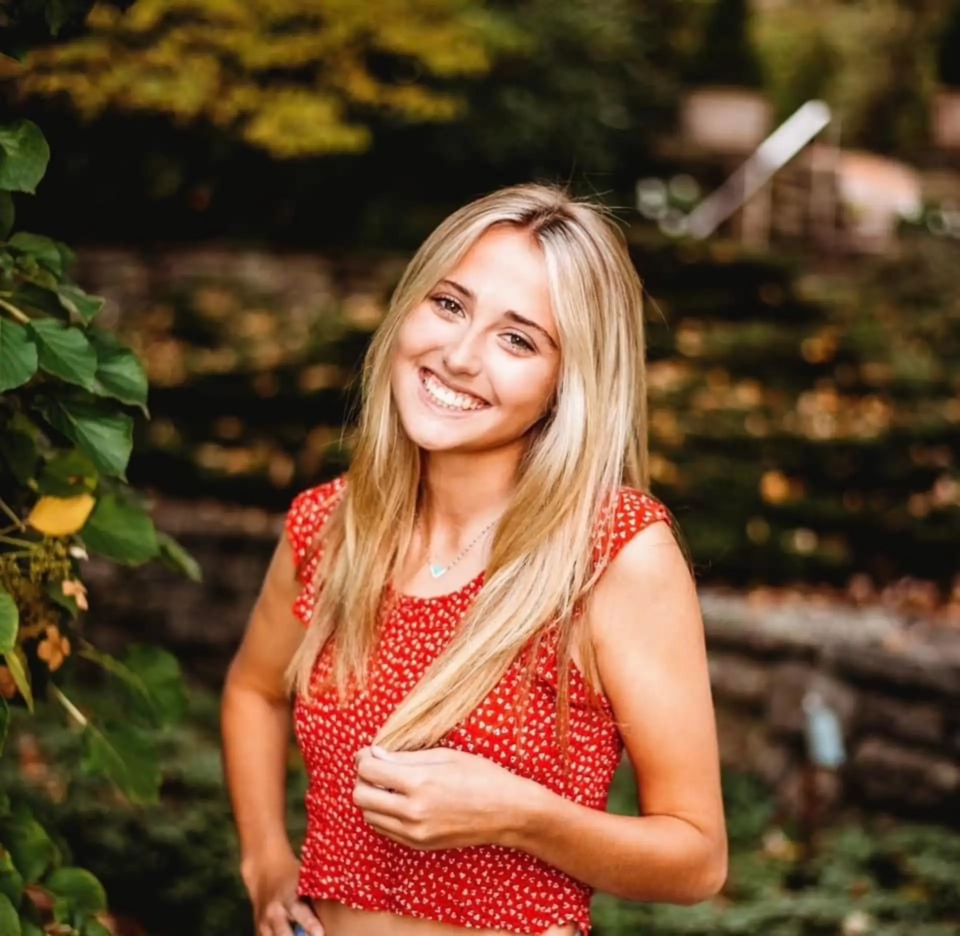 Smiling patient standing outdoors in a garden