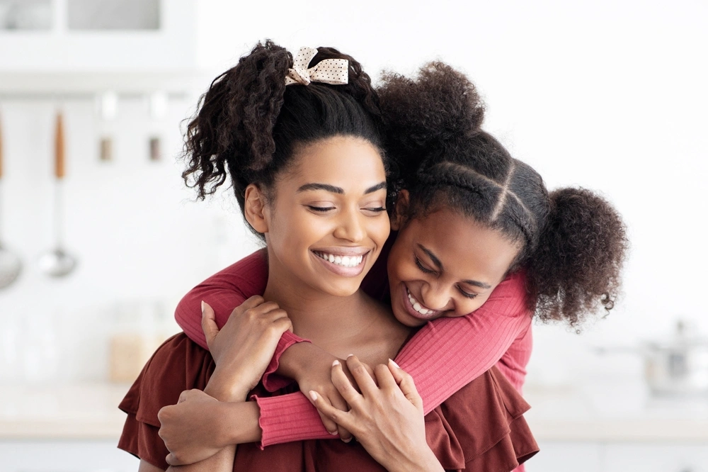 Mother and daughter smiling together